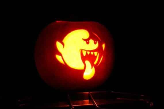Pumpkin carved with a glowing image of Ghost Boo from Mario Brothers.